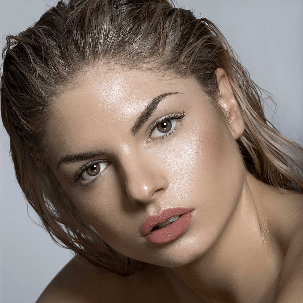Model wearing Lou Lou Lips Ned tan dusty pink lipstick