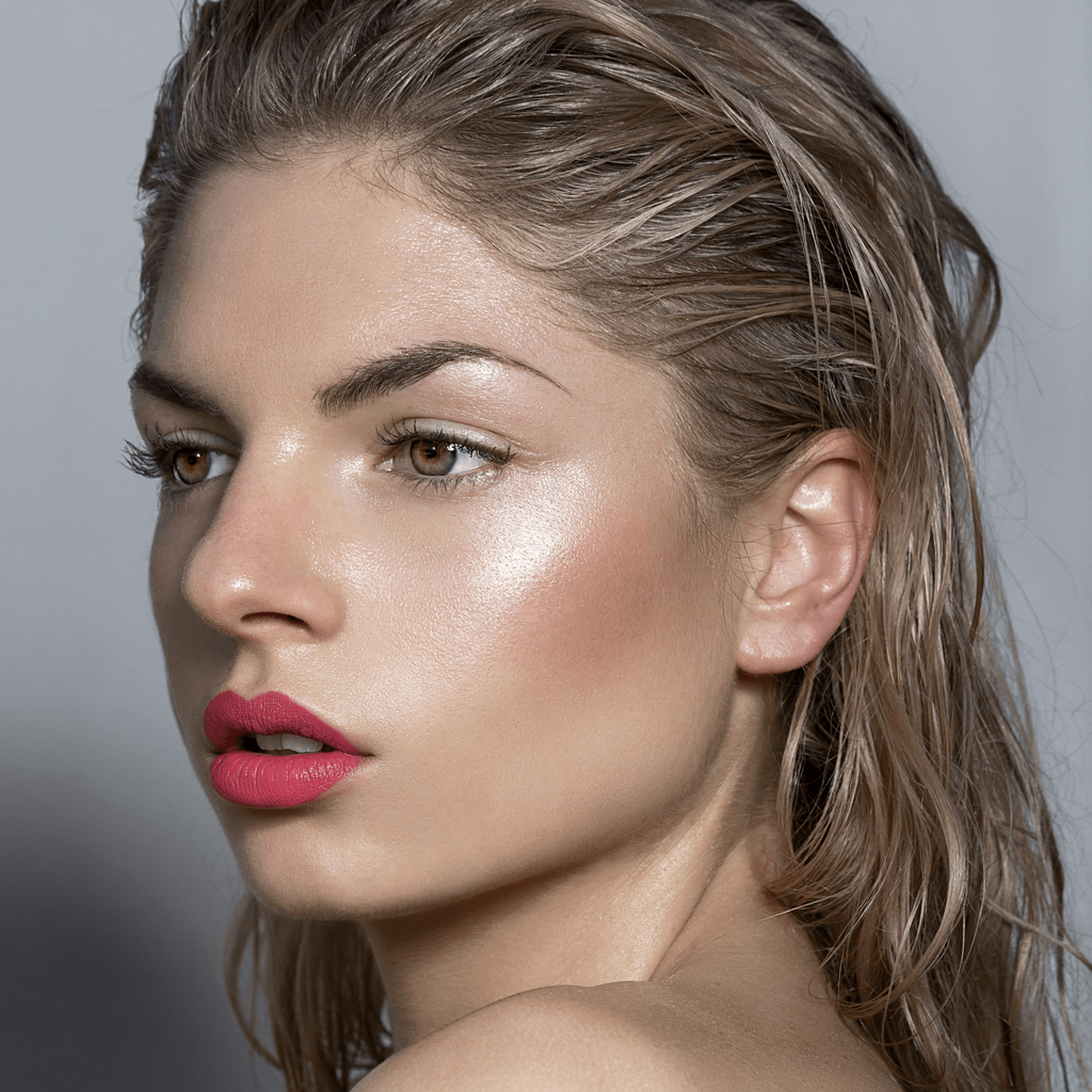 Model wearing Lou Lou Lips William coral peachy pink lipstick