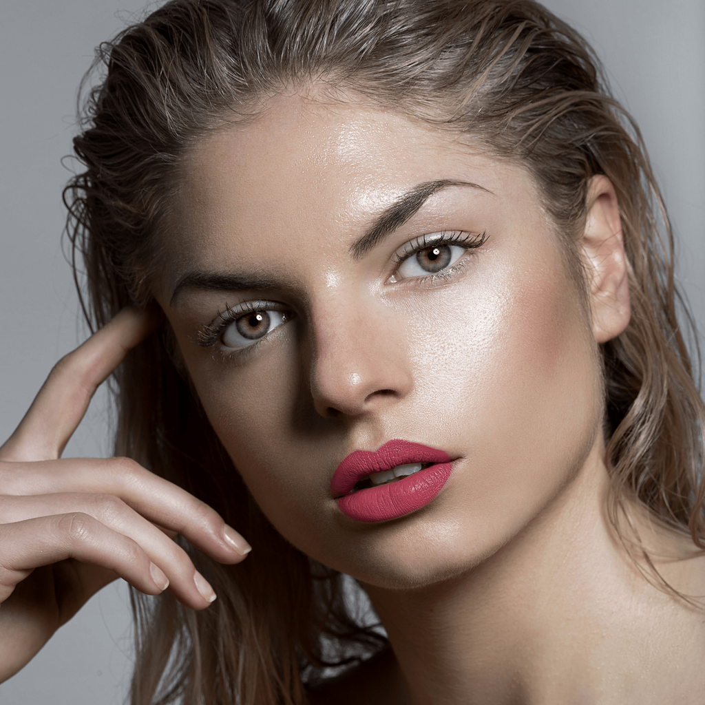 Model wearing Lou Lou Lips William coral peachy pink lipstick